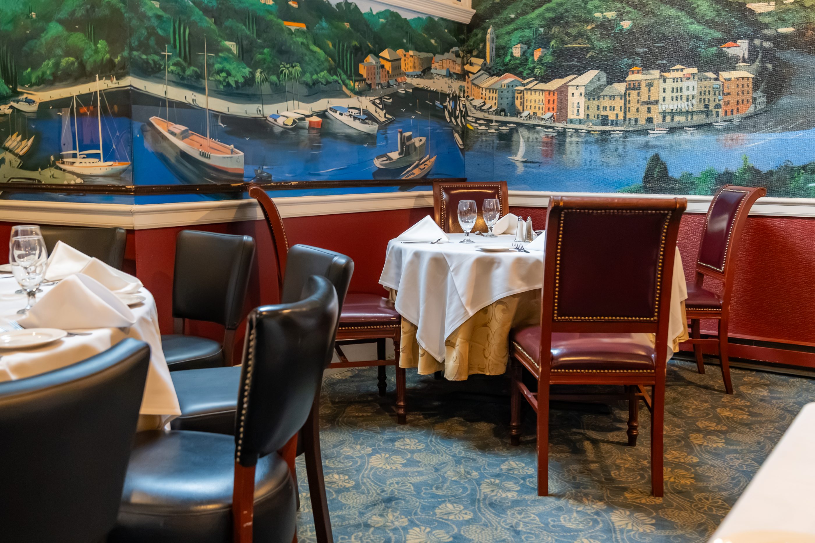 The hand-painted Portofino harbor mural running the length of a dining room at Luciano’s