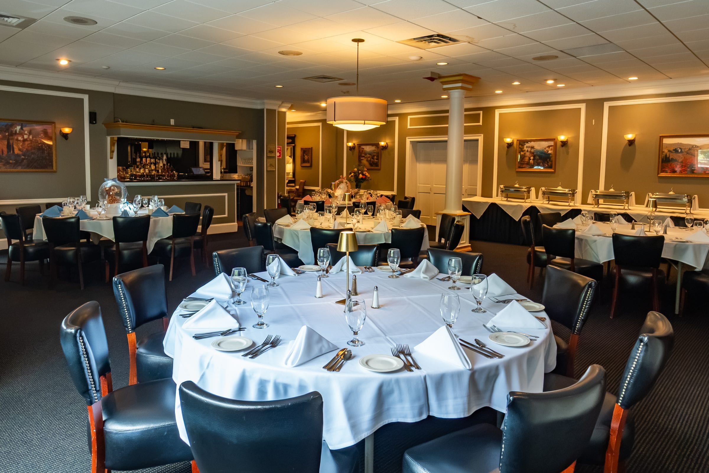 Round tables beside a buffet and a private bar
