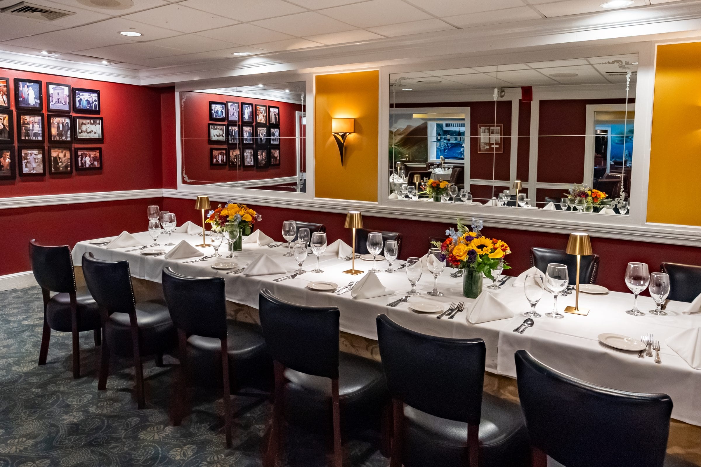 A long table in a private room hung with framed photographs