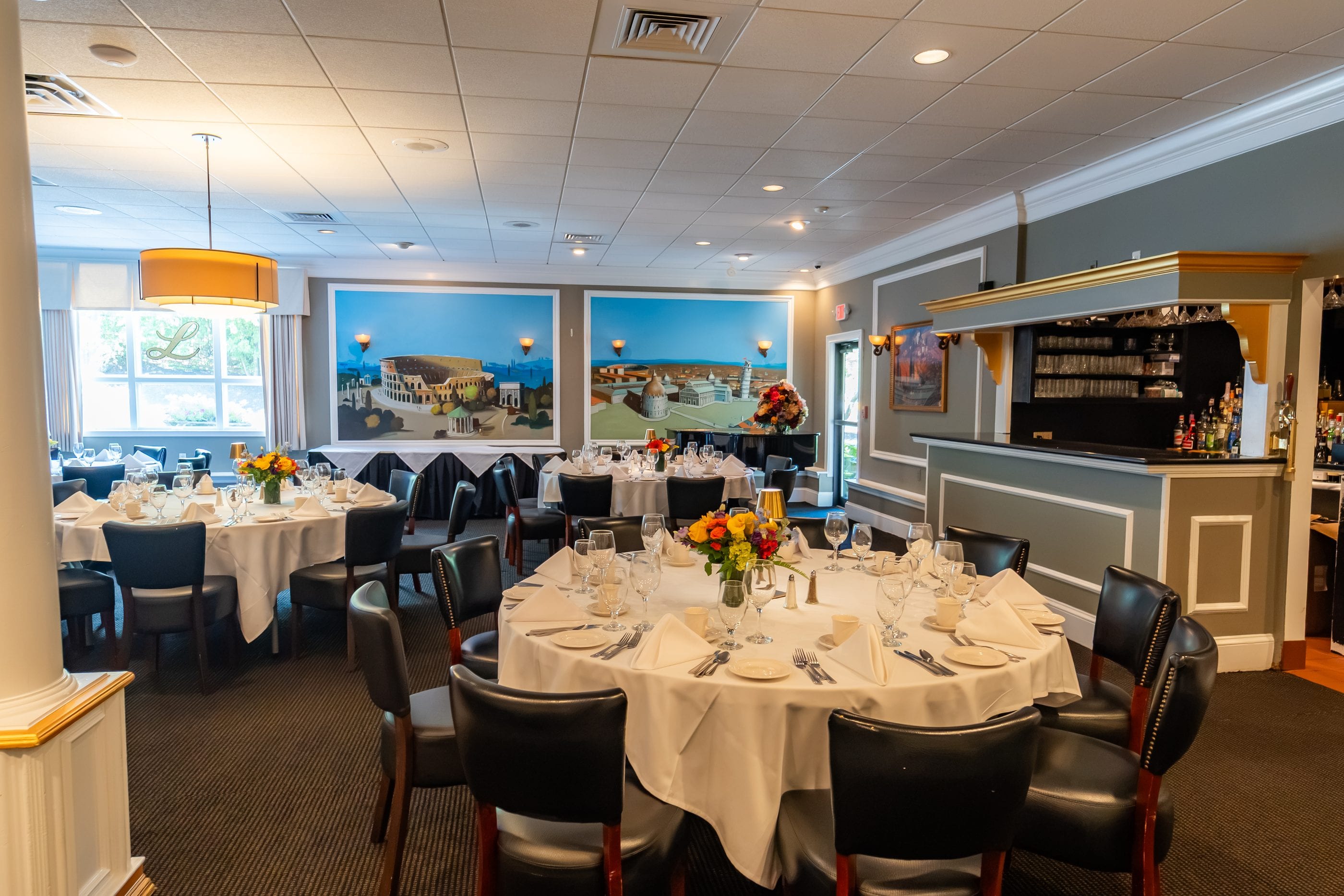 The Riviera Room at Luciano’s, with hand-painted murals, a piano and its own private bar