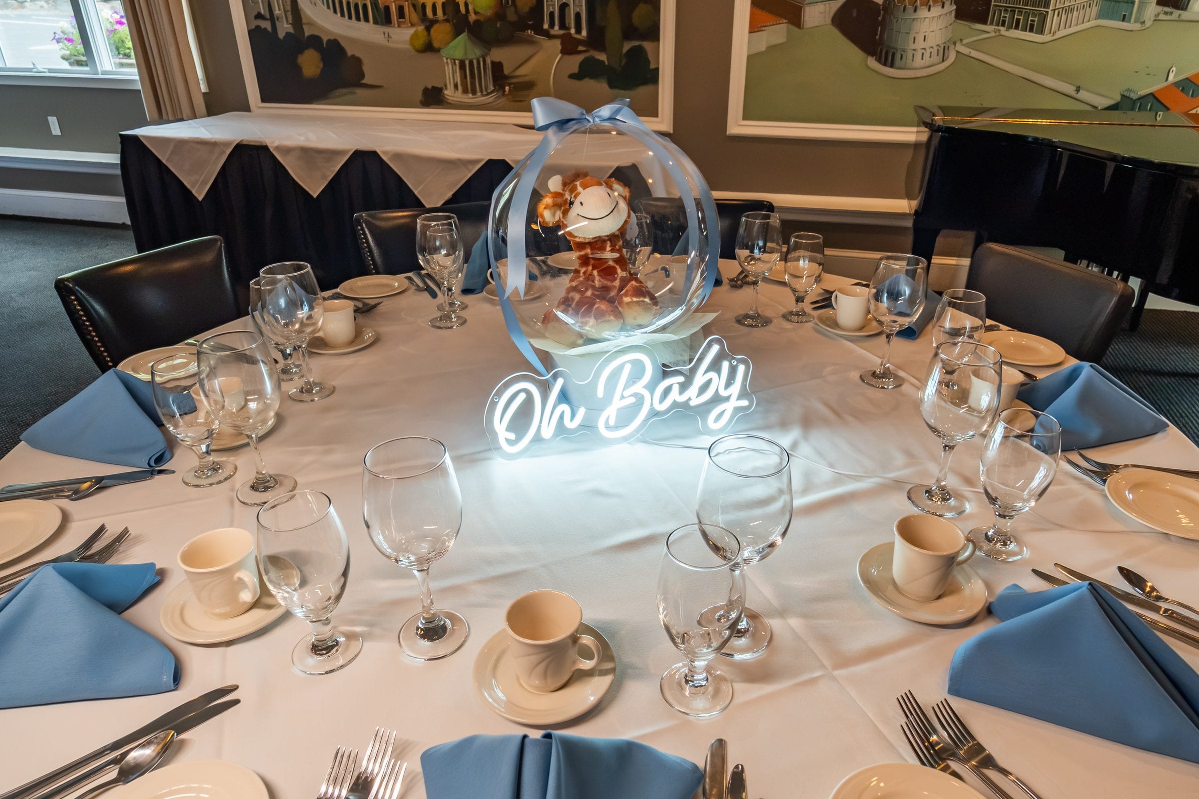 A round table dressed in blue for a baby shower