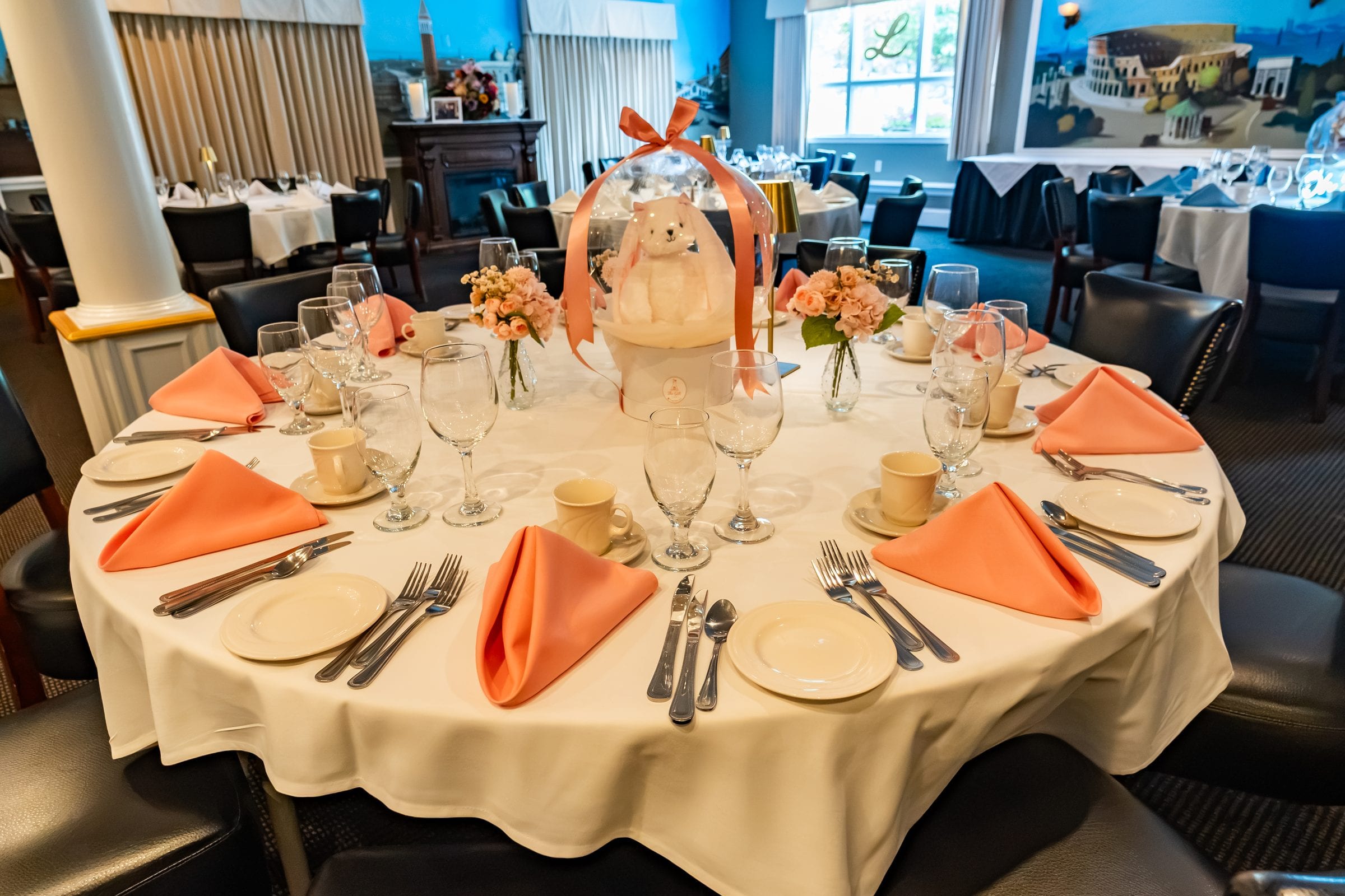 A round table dressed with peach linen for a shower